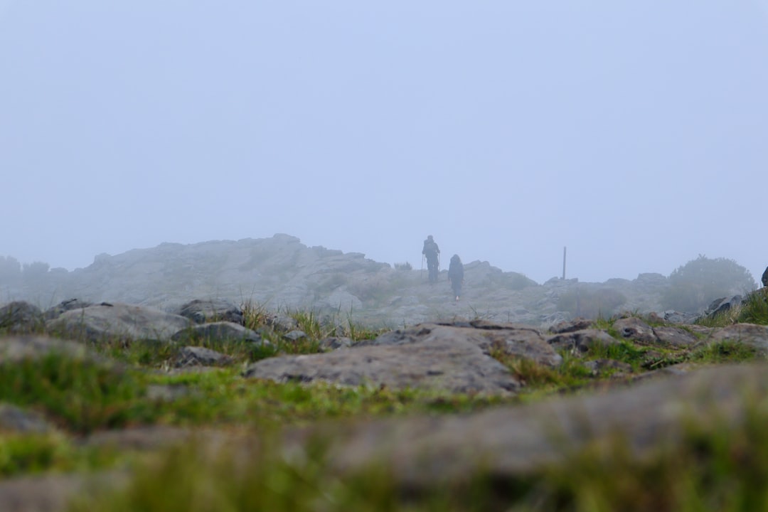 Two hikers in misty mountain landscape